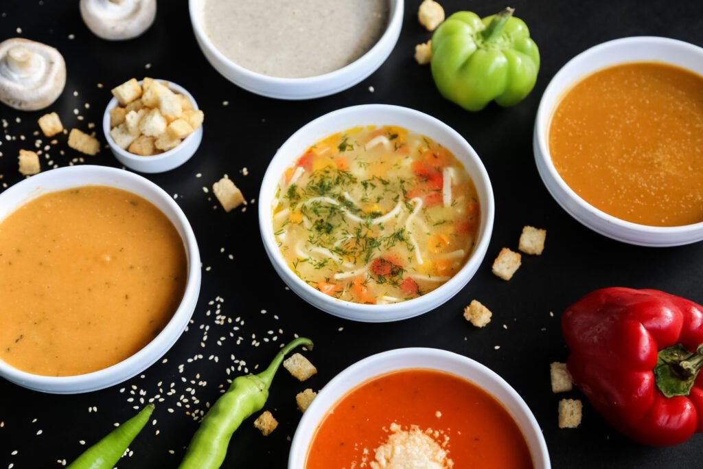 Five varieties of prepared soup arranged for refrigerated product-category evaluation
