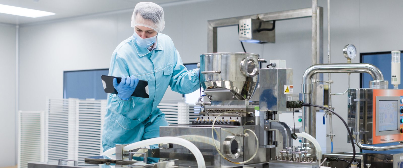 Technician reviewing processing equipment data on a tablet