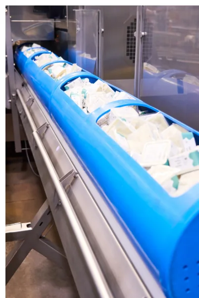 Blue HPP loading basket filled with packaged food entering high-pressure processing equipment at APC